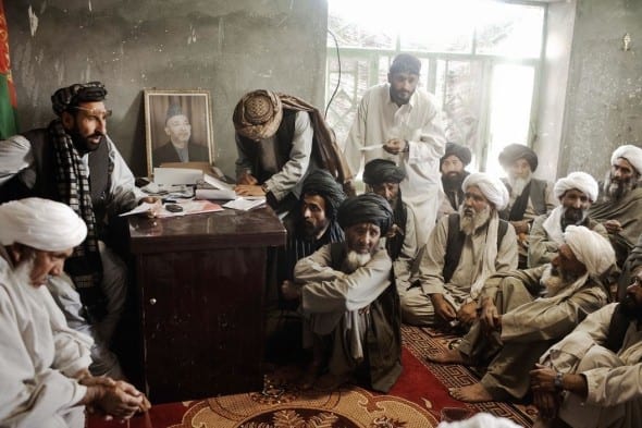 AFGHANISTAN. Marja, Helmand Province. March 2010. Marja's new district chief Hagi ZAHIR (far left top) meets with local elders in Marja's district center by Moises Saman