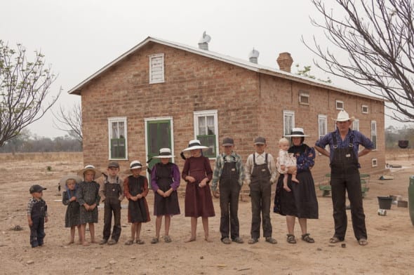 The Mennonites of Bolivia Bolivia. Durango colony. Mennonite family in front of their house (2006). From right to left: Gerhard Klassen (36), Anna Bren (35) with baby Sarah (1), Heinrich (13), Peter (12), Eva (11), Catarina (9), Anna (8), Gerhard (6), Elisabet (5), Elena (3) and Jacob (2). by Jordi Busque