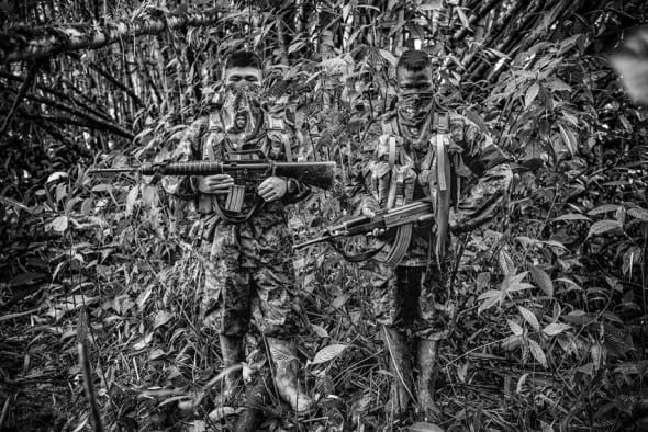 Born in Conflict February 17, 2014. Angel(14) y Daniel (16) (right) members of the ELN front Che Guevara pose for a picture at their camp in Chocó, Colombia. by Juan Arredondo