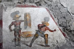 affresco che riprende un combattimento tr gladiatori
