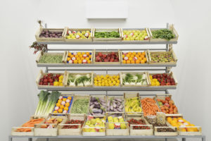 Giuseppe De Mattia, Espositore di frutta e verdura, 2019, Iron structure, wooden boxes and polypropylene pockets, fresh fruit and vegetables, ceramic sculptures painted with pure pigment, Ed. 1/3 + 1AP, 285 x 250 x 120 cm - Courtesy Materia Gallery Roma, ph. Roberto Apa
