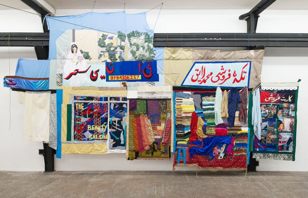 Hangama Amiri, Bazaar, 2020, cotton, chiffon, muslin, silk, suede, digitally woven textile, camouflage fabric, sari textile, inkjet prints on paper and canvaspaper, plastic, acrylic paint, marker, polyester, table cloth, faux leather and found fabrics, 427 × 793 cm - Courtesy T293 Roma, ph. Roberto Apa