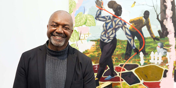 Kerry James Marshall at the 2014 Wolfgang Hahn-Prize Award Ceremony in the Museum Ludwig, in front of the work acquired for the Museum, Vignette #15, 2014. © Kerry James Marshall and the Museum Ludwig. Courtesy of the artist. Photo: Jürgen Schulzki.