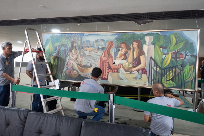 Experts examine Emiliano Di Cavalcanti's Mulatas (1962), which had been punctured by protesters. The Brazilian government has said it is worth at least $1.5 million. PHOTO ANDRESSA ANHOLETE/GETTY IMAGES