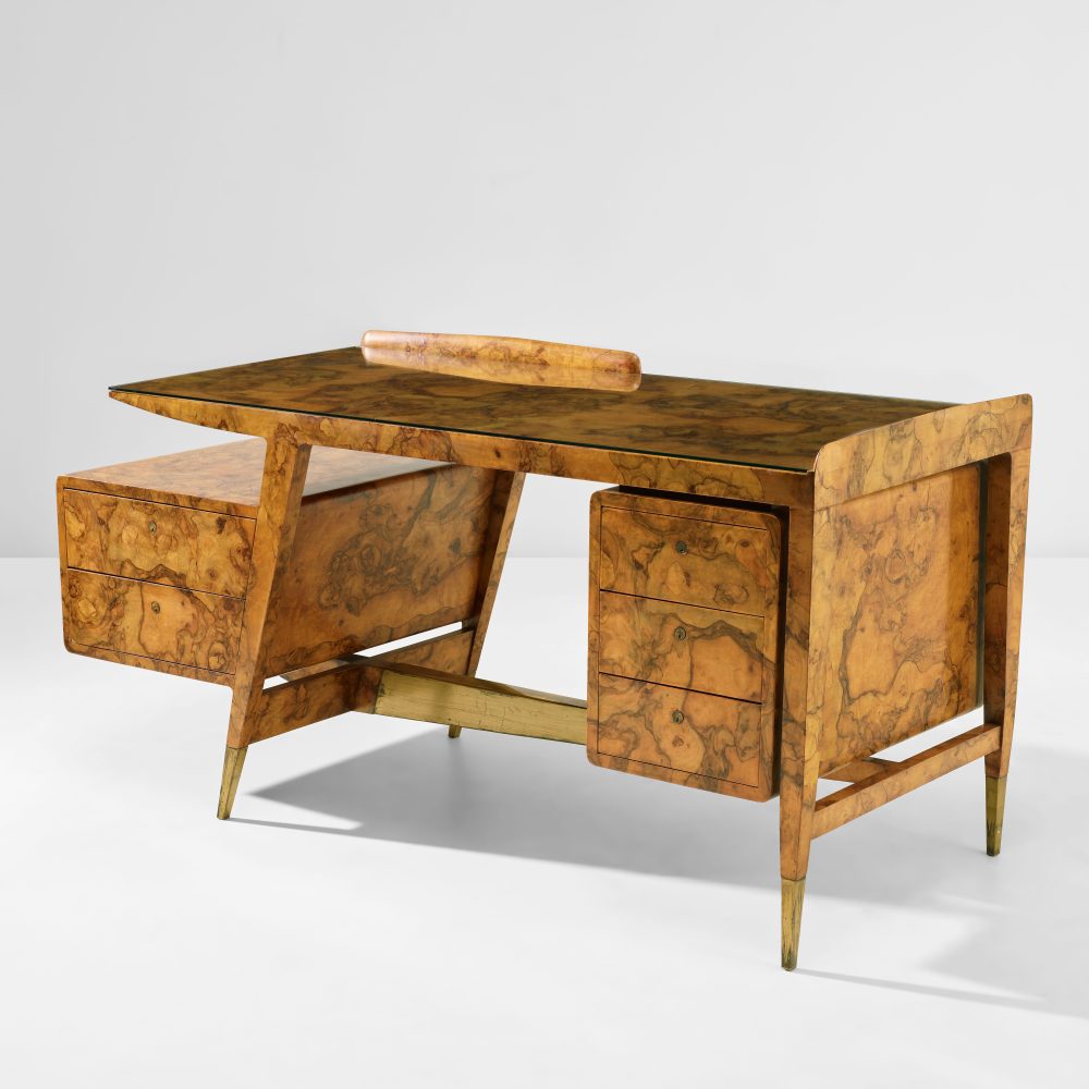 GIO PONTI 1891 - 1979 Desk, from Casa di Fantasia, Milan circ a 1951 Burr - walnut veneered wood, glass, brass. 83 x 166 x 69 cm (32 5/8 x 65 3/8 x 27 1/8 in.) Executed by Giordano Chiesa, Milan, Italy. Together with a certificate of expertise from the Gio Ponti Archives. ESTIMATE £80,000 - 120,000
