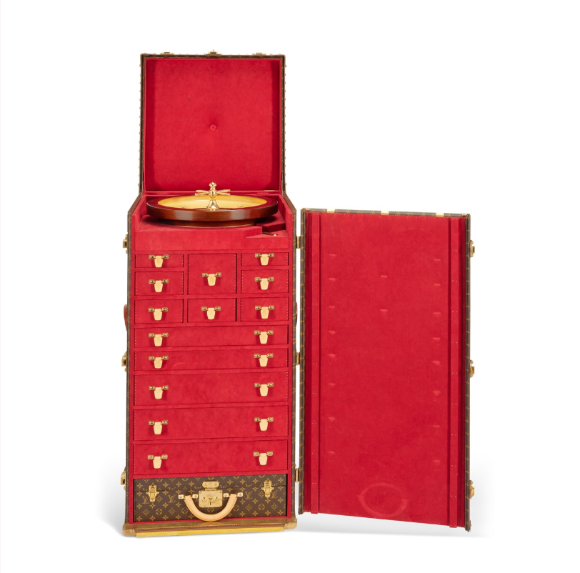 A rare, monogram canvas casino trunk with brass hardware. Sold for 75.600