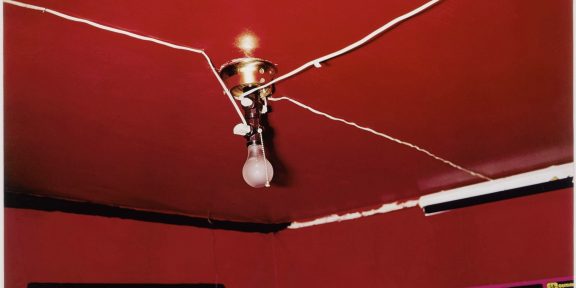 William Eggleston (b. 1939), Greenwood, Mississippi (Red Ceiling), 1973. Dye transfer print. 12 ¼ x 18 ½ in (31.1 x 47 cm). Estimate: $200,000–300,000. Offered in: An Eye Towards the Real: Photographs from the Collection of Ambassador Trevor Traina on 3 October 2024 at Christie's in New York