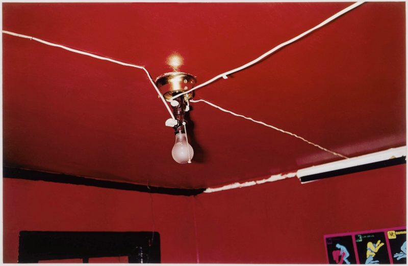 William Eggleston (b. 1939), Greenwood, Mississippi (Red Ceiling), 1973. Dye transfer print. 12 ¼ x 18 ½ in (31.1 x 47 cm). Estimate: $200,000–300,000. Offered in: An Eye Towards the Real: Photographs from the Collection of Ambassador Trevor Traina on 3 October 2024 at Christie's in New York
