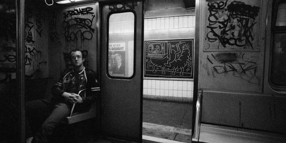 Tseng Kwong Chi Keith Haring, drawing in the subway, New York, circa 1983. Photo © Muna Tseng Dance Projects, Inc. Art © Keith Haring Foundation