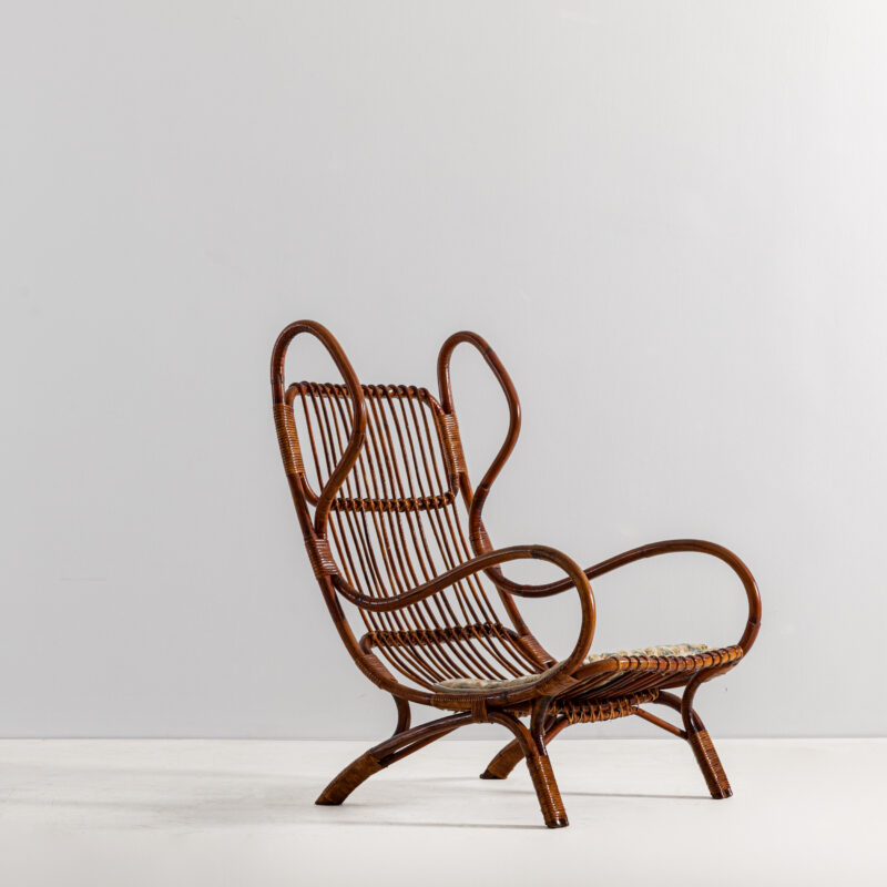 Lotto 215 GIO PONTI Poltrona mod. Continuum. Canna d'India, midollino intrecciato, tessuto imbottito. Italia anni '50. STIMA € 2.000 - 3.000 Wannenes