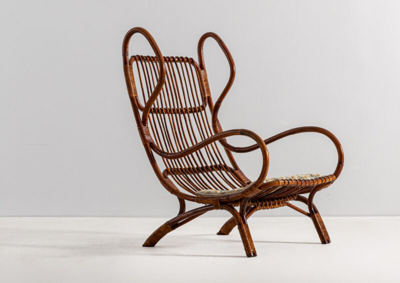 Lotto 215 GIO PONTI Poltrona mod. Continuum. Canna d'India, midollino intrecciato, tessuto imbottito. Italia anni '50. STIMA € 2.000 - 3.000 Wannenes