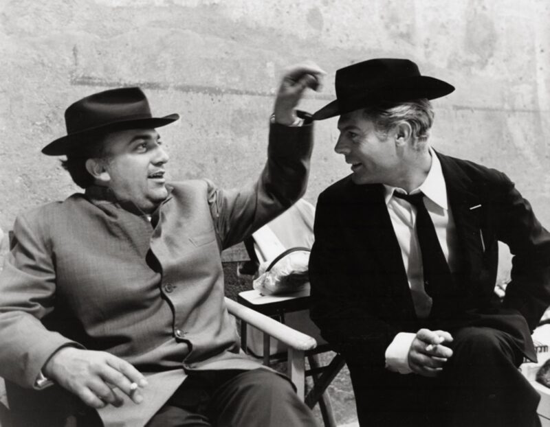 Tazio Secchiaroli, Federico Fellini e Marcello Mastroianni durante una pausa di 8 ½, Cinecittà, Roma, 1963, Gelatin Silver Print, 30x40 cm, Estate signed print - open edition. Courtesy: © David Secchiaroli / Courtesy Admira