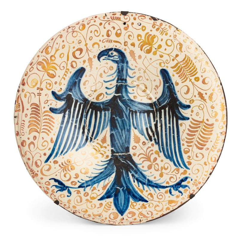 Lotto 314FORNACE DI MANISES Grande piatto da parata in maiolica lustrata, decorato con un’aquila blu araldica su un fondo a racemi vegetali. Inizio del XVI secolo. Etichetta di collezione. Alt. cm 5,5, diam. cm 53,7. AGGIUDICAZIONE: 35.150 EURO Wannenes