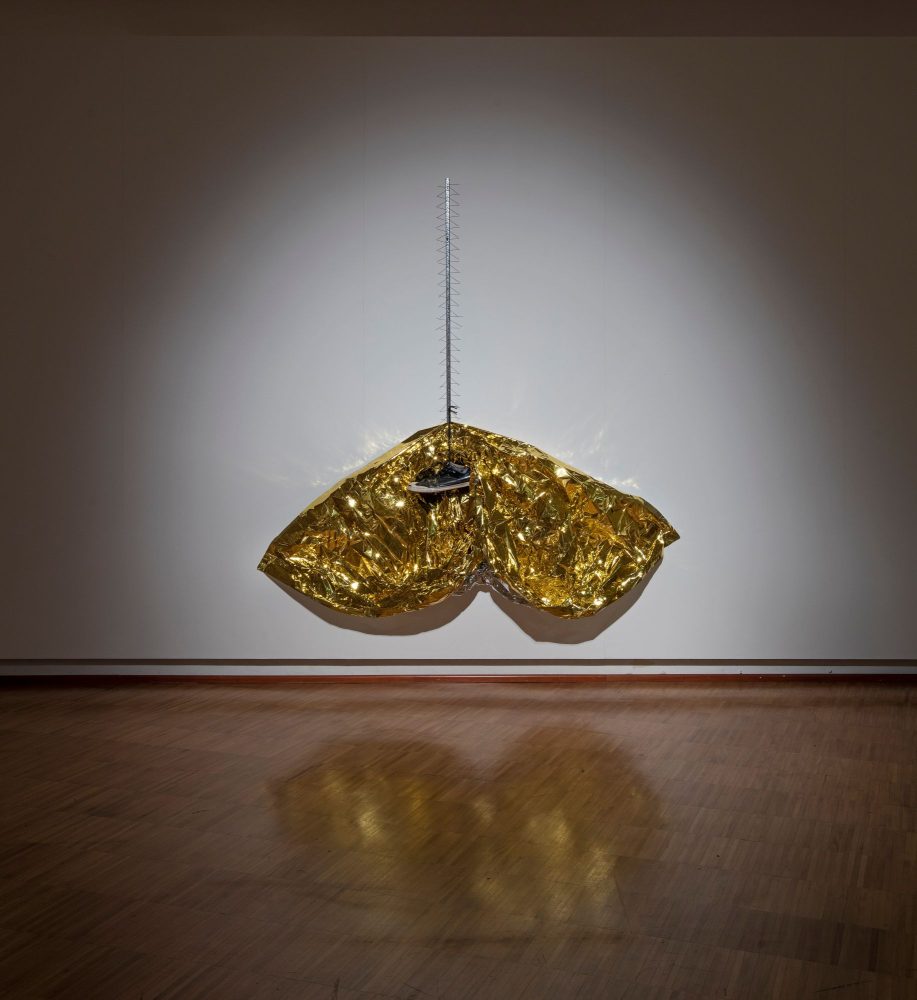 Bruna Esposito, Tramonto, 2014. Rescue blanket, bird spikes, shoe, 65 x 52 ¾ in. (165 x 134 cm), courtesy Wizard Gallery, Milano, foto courtesy Fondazione Lercaro Bologna, foto credit © Antonio Maniscalco – Milan, Paris